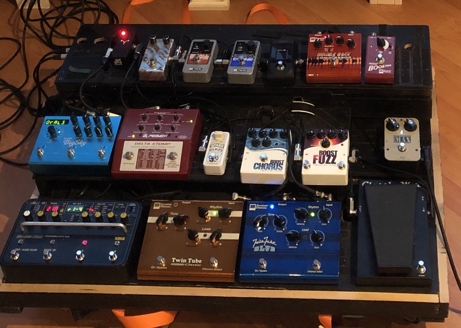 A pedalboard filled with colourful guitar effects pedals