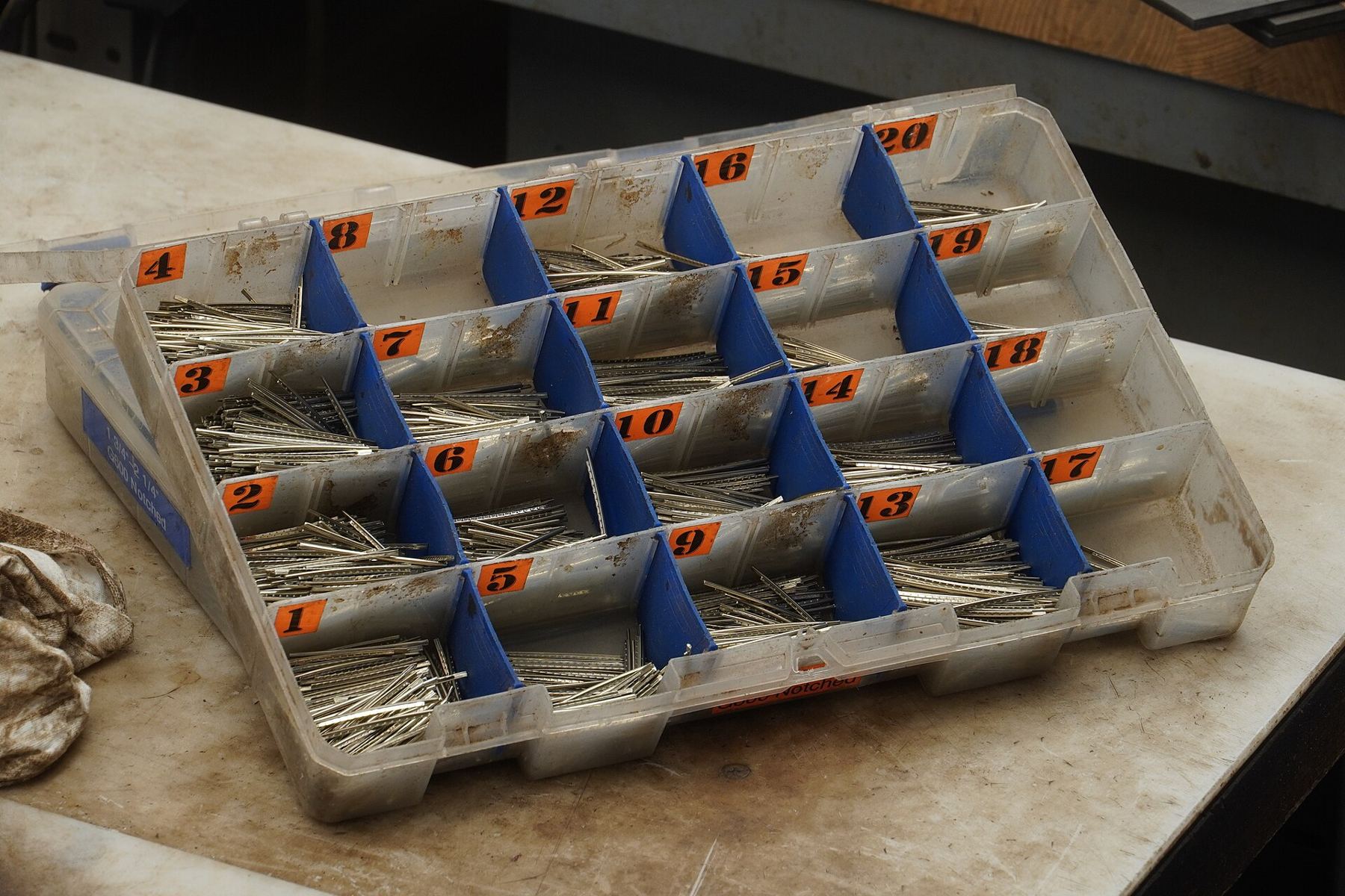A sorted tray of small replacement parts and fret wire